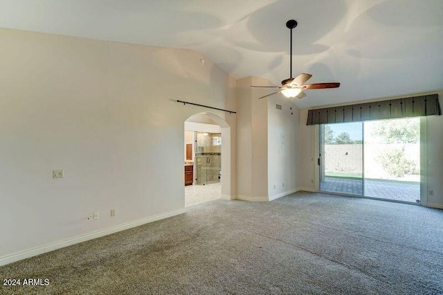 spare room with light carpet, vaulted ceiling, and ceiling fan