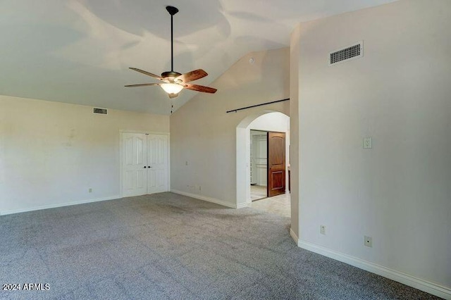 carpeted spare room with high vaulted ceiling and ceiling fan