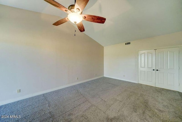 unfurnished bedroom with lofted ceiling, carpet floors, a closet, and ceiling fan