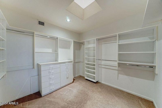 walk in closet featuring light colored carpet