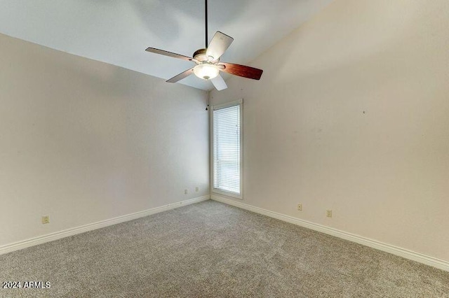 carpeted empty room with vaulted ceiling and ceiling fan