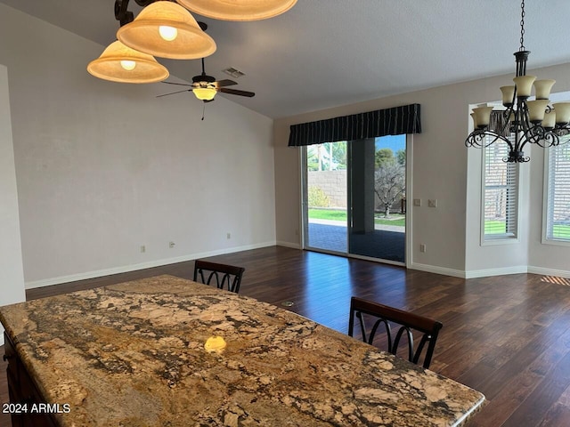 dining area featuring vaulted ceiling, dark hardwood / wood-style flooring, plenty of natural light, and ceiling fan with notable chandelier