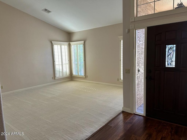 foyer featuring hardwood / wood-style flooring and lofted ceiling