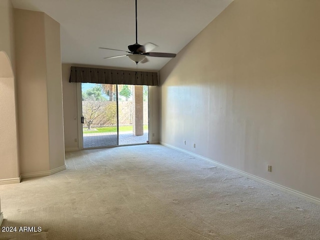 carpeted empty room featuring lofted ceiling and ceiling fan