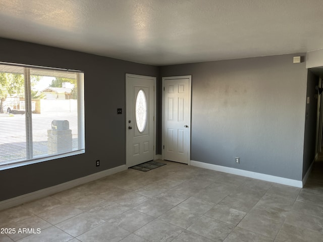 foyer featuring a textured ceiling