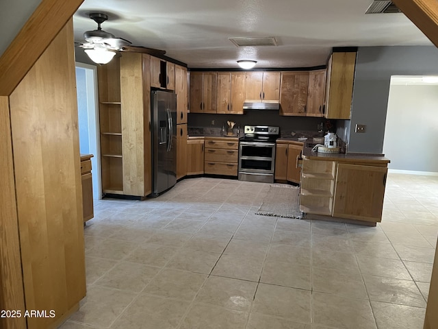 kitchen with ceiling fan, stainless steel appliances, and light tile patterned floors