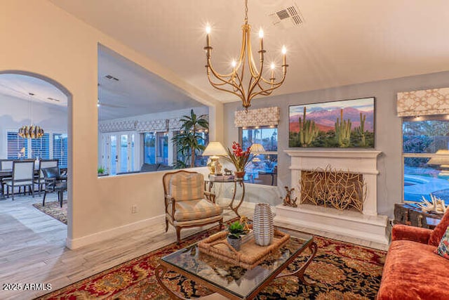 living room with wood-type flooring and a chandelier