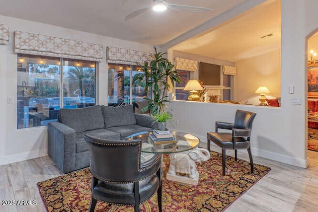 living room featuring hardwood / wood-style floors and ceiling fan