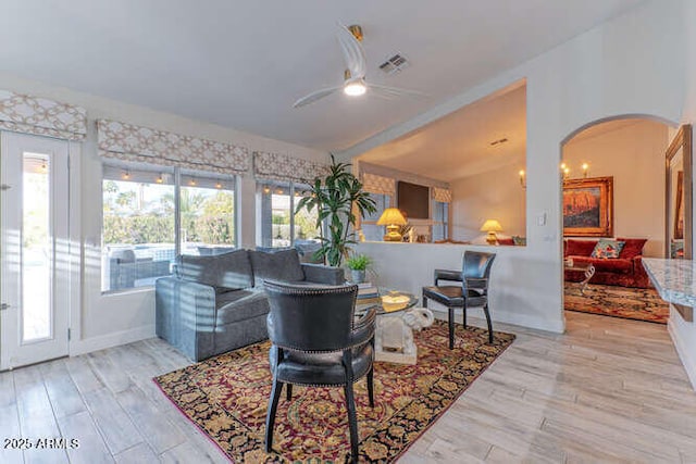 living room with light hardwood / wood-style flooring and ceiling fan