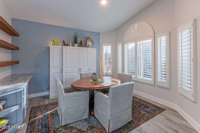 dining space with light hardwood / wood-style flooring