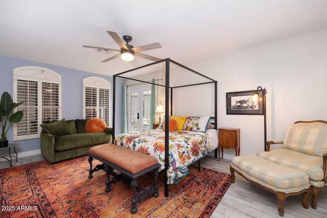 bedroom with light hardwood / wood-style flooring, french doors, and ceiling fan