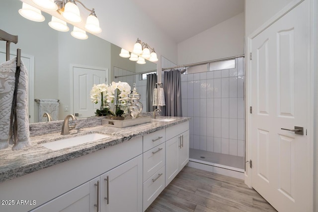 bathroom featuring hardwood / wood-style floors, a chandelier, and a shower with shower curtain