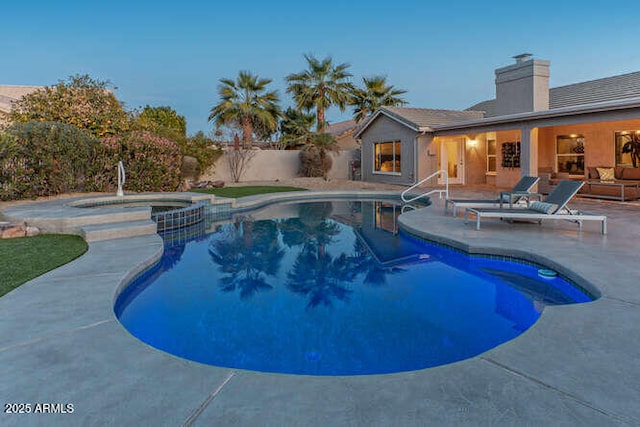 view of swimming pool featuring an in ground hot tub and a patio area