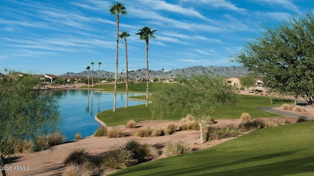 view of home's community featuring a water and mountain view and a lawn