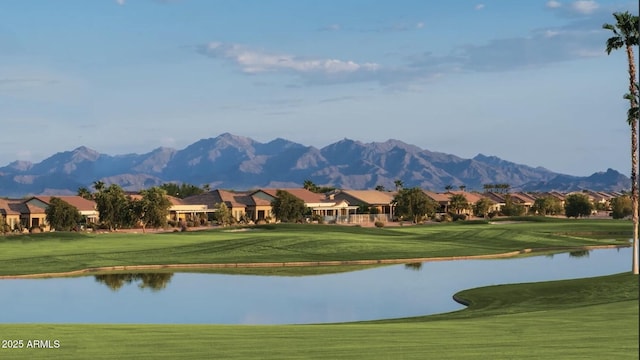 surrounding community with a water and mountain view and a lawn