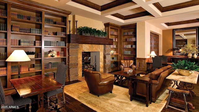 sitting room featuring coffered ceiling, a stone fireplace, beamed ceiling, and light wood-type flooring