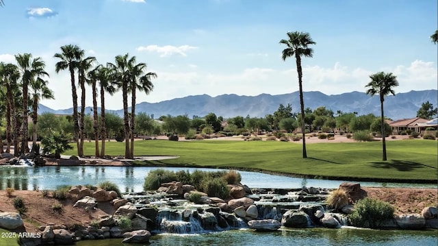 surrounding community with a water and mountain view and a lawn