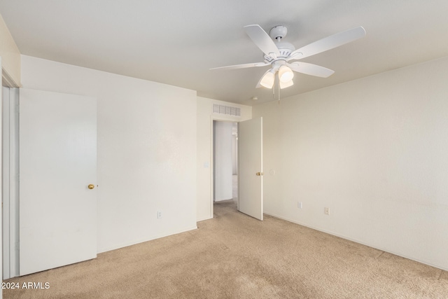 empty room with ceiling fan and light colored carpet