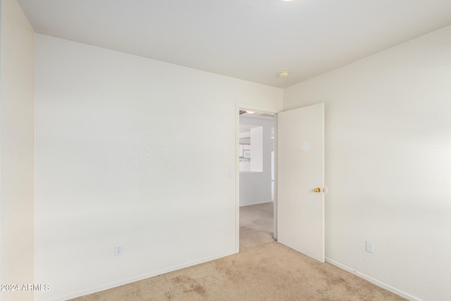 unfurnished room with light colored carpet