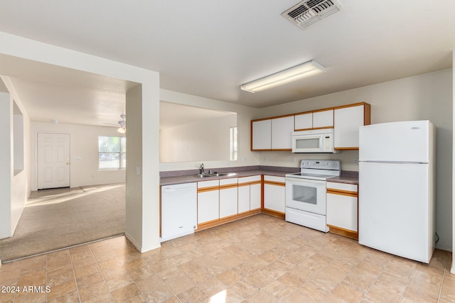 kitchen with white appliances, light carpet, sink, ceiling fan, and white cabinetry