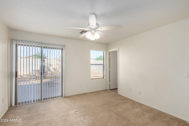 carpeted empty room featuring ceiling fan