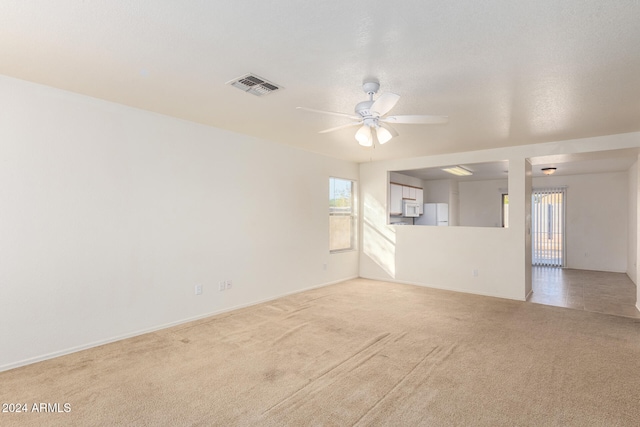 spare room with carpet and ceiling fan