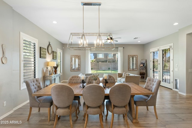 dining area featuring recessed lighting, a notable chandelier, baseboards, and light wood-type flooring