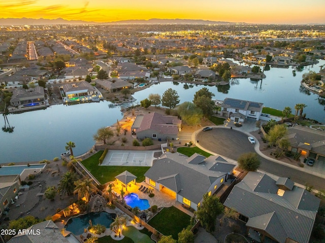 birds eye view of property with a residential view and a water view