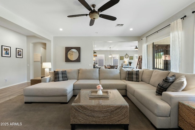 living area featuring recessed lighting, visible vents, baseboards, and wood finished floors