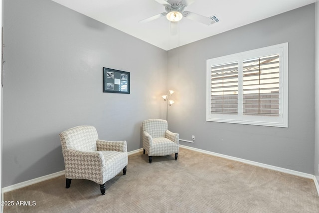 sitting room featuring visible vents, baseboards, and carpet