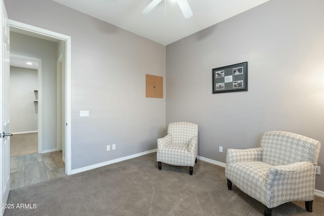 sitting room with baseboards, ceiling fan, and carpet flooring
