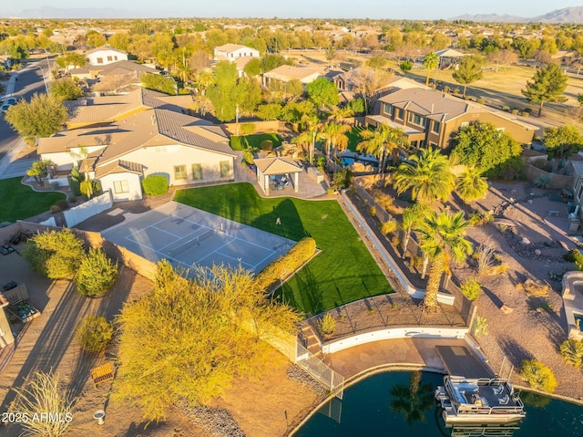drone / aerial view with a residential view and a water view