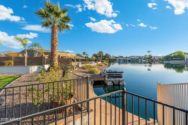 water view featuring a dock and fence