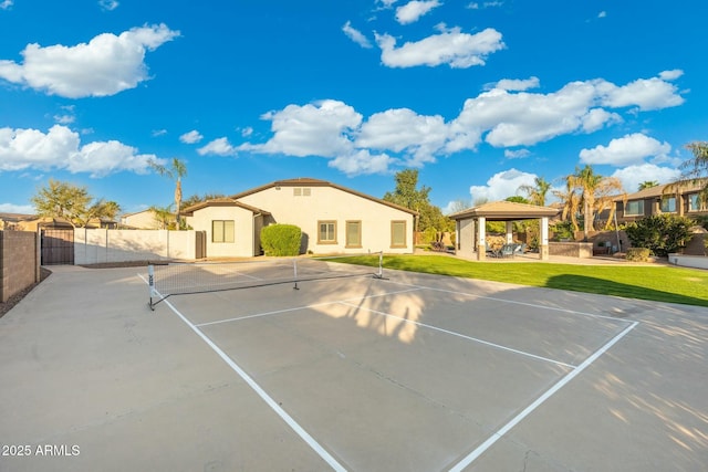 view of sport court with a gazebo, a lawn, a gate, and fence
