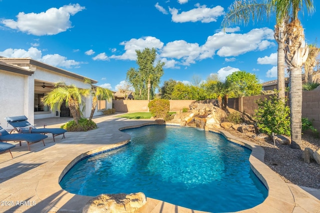 view of swimming pool featuring a patio area, ceiling fan, a fenced backyard, and a fenced in pool
