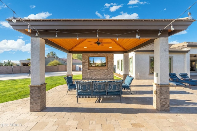 view of patio with a gazebo, outdoor dining space, and ceiling fan