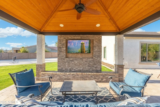 view of patio with a gazebo, an outdoor living space, ceiling fan, and fence