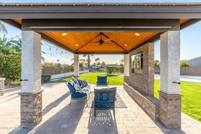 view of patio / terrace with a gazebo, a ceiling fan, and fence