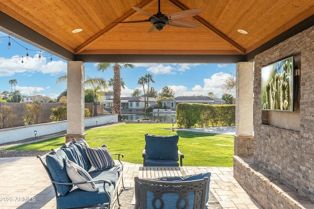 view of patio / terrace featuring a ceiling fan, a fenced backyard, a gazebo, a residential view, and outdoor lounge area