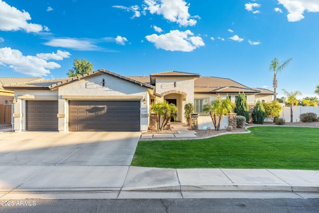 mediterranean / spanish-style house featuring a front yard, driveway, an attached garage, stucco siding, and a tile roof