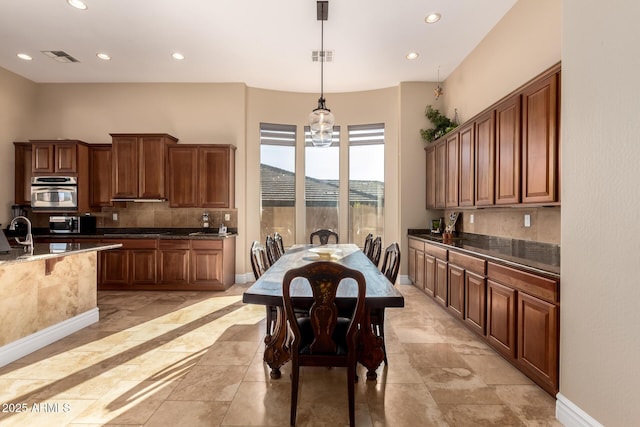 dining space featuring an inviting chandelier and sink