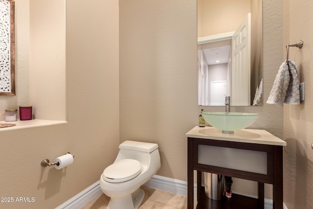 bathroom featuring tile patterned floors, vanity, and toilet