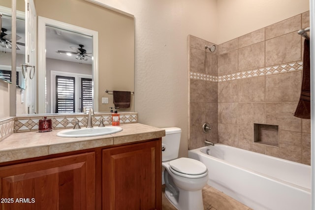 full bathroom featuring ceiling fan, vanity, tasteful backsplash, toilet, and tiled shower / bath