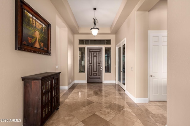 foyer featuring a tray ceiling