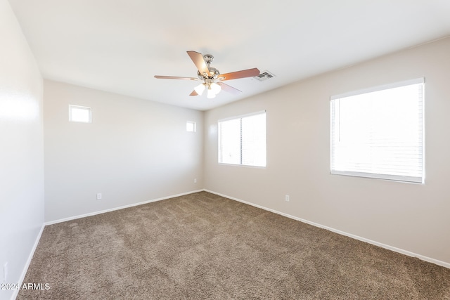 carpeted empty room featuring ceiling fan