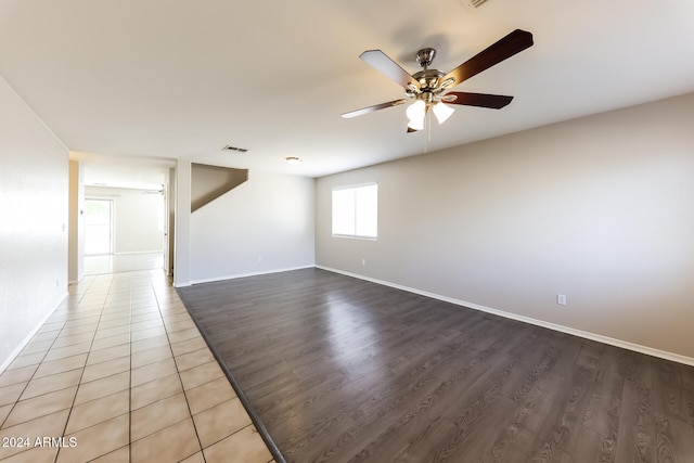 empty room with hardwood / wood-style flooring and ceiling fan