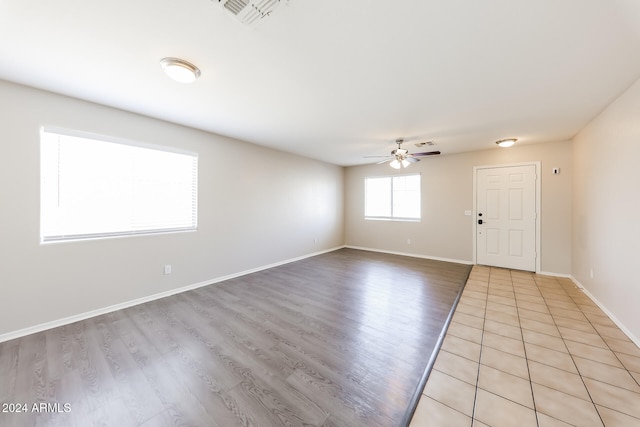 interior space with ceiling fan and light hardwood / wood-style floors