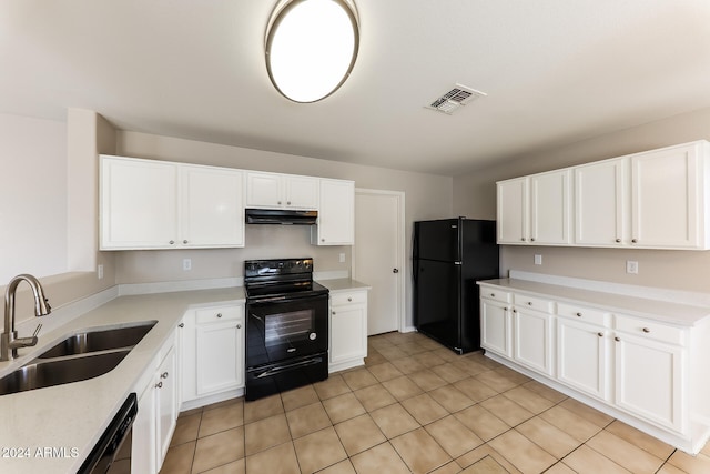 kitchen with black appliances, white cabinets, light tile patterned floors, and sink