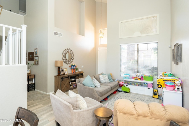 2224 W Olive Way, Chandler, AZ 85248 - living room featuring a towering ceiling, light wood-style floors, and baseboards