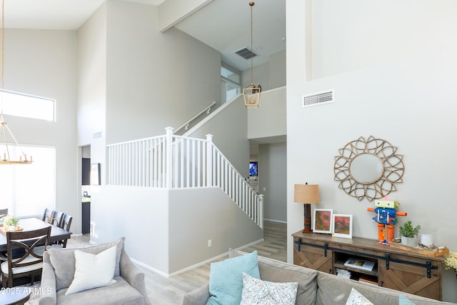 2224 W Olive Way, Chandler, AZ 85248 - living room featuring high vaulted ceiling, stairway, wood finished floors, beam ceiling, and a chandelier
